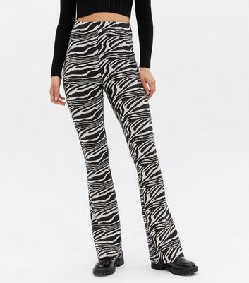 Click to view product details and reviews for Tall Black Zebra Print Jersey Flared Trousers New Look.