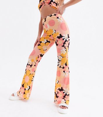 Click to view product details and reviews for Psychedelic Petite Orange Floral Flared Trousers New Look.