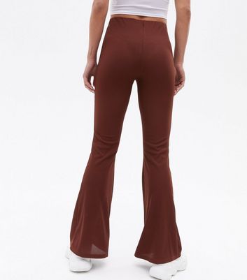 Click to view product details and reviews for Dark Brown Ribbed Jersey High Waist Flared Trousers New Look.