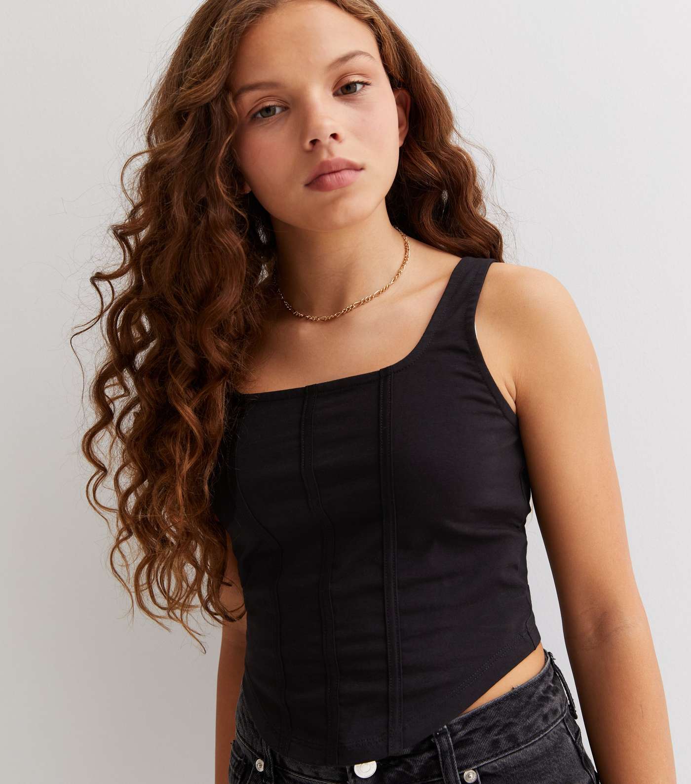 https://media2.newlookassets.com/i/newlook/850571401M1/girls/clothing/tops/girls-black-corset-top.jpg?strip=true&w=1400&qlt=60&fmt=jpeg