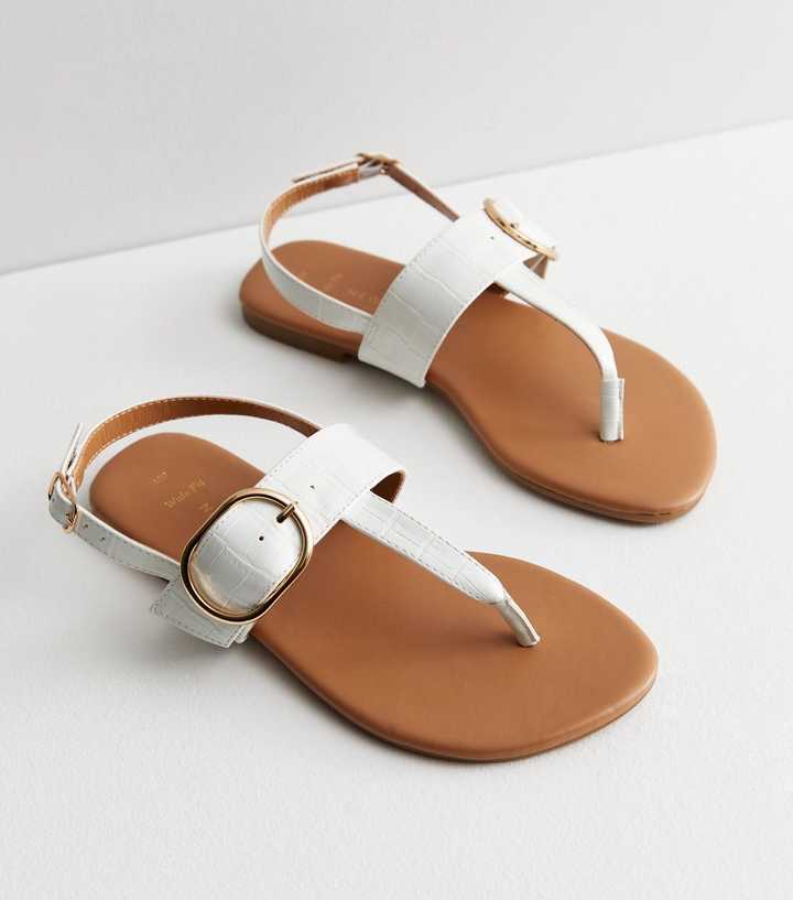 https://media2.newlookassets.com/i/newlook/852270710/womens/footwear/shoes/wide-fit-white-leather-look-buckle-toe-post-sandals.jpg?strip=true&qlt=50&w=720