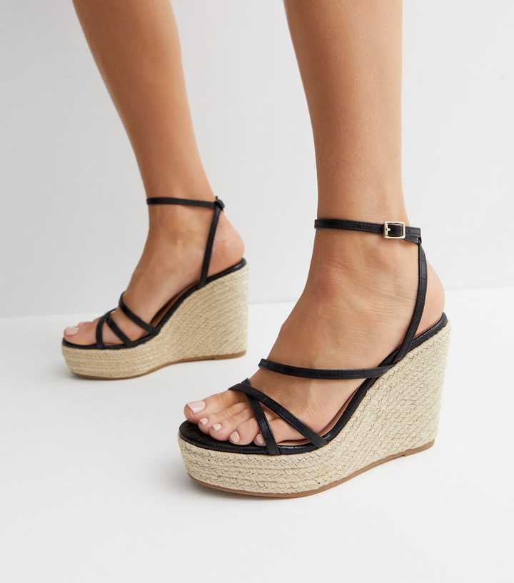 https://media2.newlookassets.com/i/newlook/852376101M1/womens/footwear/shoes/black-faux-croc-strappy-espadrille-wedge-heel-sandals.jpg?strip=true&qlt=50&w=720