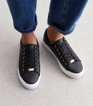 black trainers with gold trim