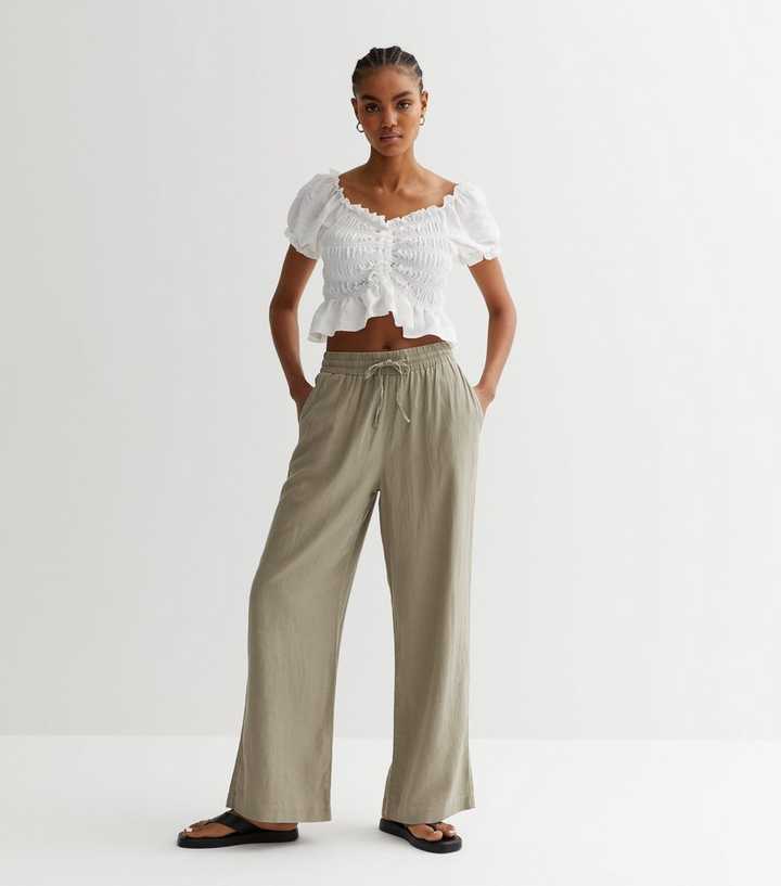 https://media2.newlookassets.com/i/newlook/855387034/womens/clothing/trousers/khaki-linen-blend-wide-leg-trousers.jpg?strip=true&qlt=50&w=720