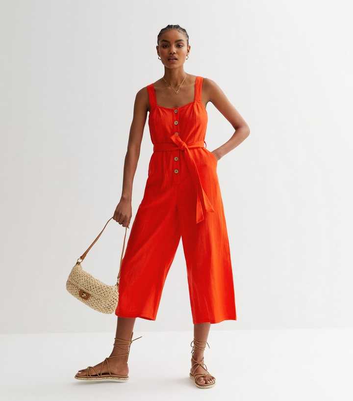 https://media2.newlookassets.com/i/newlook/859726460/womens/clothing/playsuits-jumpsuits/red-cotton-button-front-wide-leg-jumpsuit.jpg?strip=true&qlt=50&w=720