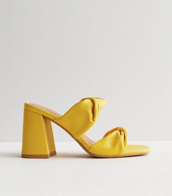 Yellow block store heel mules