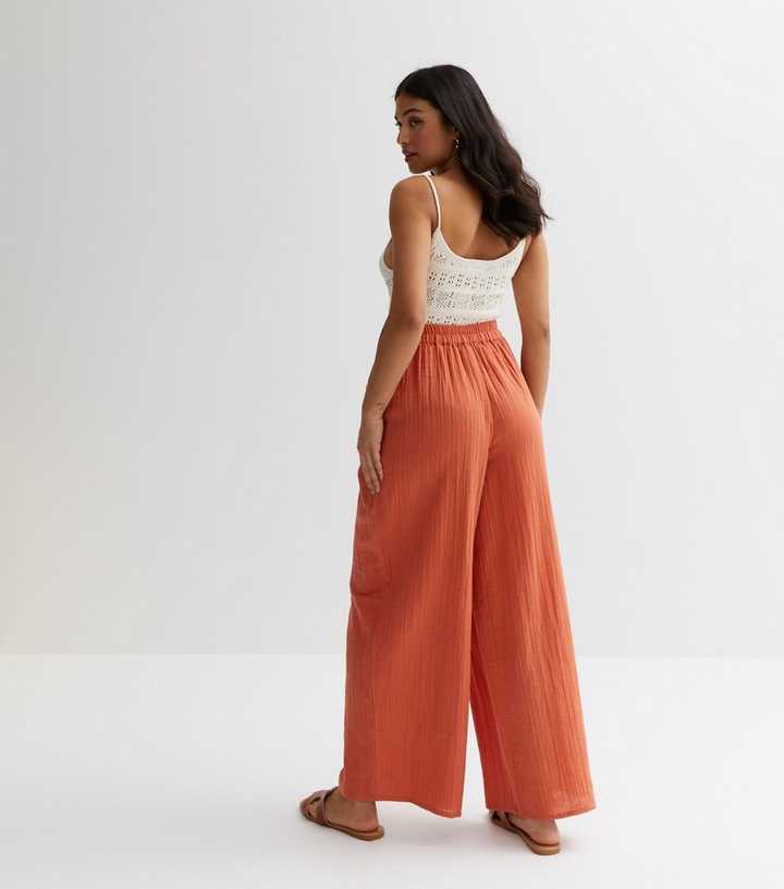 Red pleated wide leg trousers