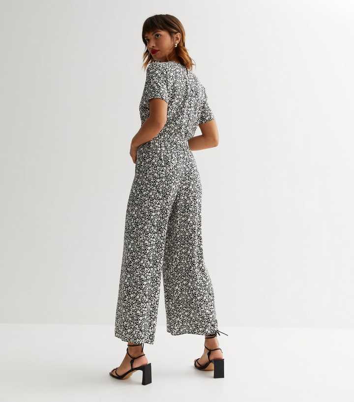 https://media2.newlookassets.com/i/newlook/864451109M3/womens/clothing/playsuits-jumpsuits/black-ditsy-floral-belted-wrap-crop-jumpsuit.jpg?strip=true&qlt=50&w=720