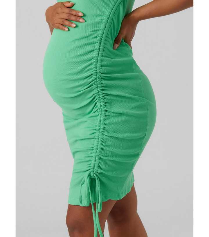 https://media2.newlookassets.com/i/newlook/868569430M2/womens/clothing/dresses/mamalicious-maternity-green-ribbed-ruched-mini-dress.jpg?strip=true&qlt=50&w=720