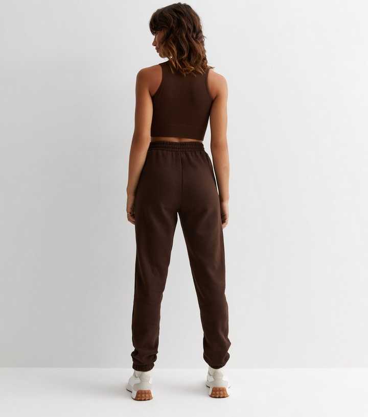 https://media2.newlookassets.com/i/newlook/872312727M3/womens/clothing/dark-brown-cuffed-joggers.jpg?strip=true&qlt=50&w=720