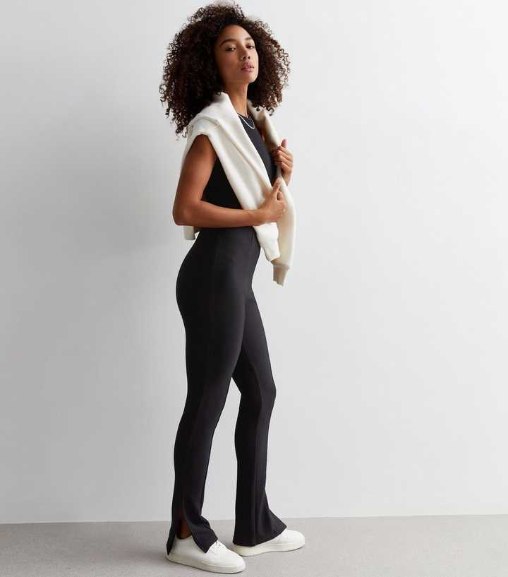 https://media2.newlookassets.com/i/newlook/877571201/womens/clothing/leggings/black-ribbed-split-hem-flared-leggings.jpg?strip=true&qlt=50&w=720