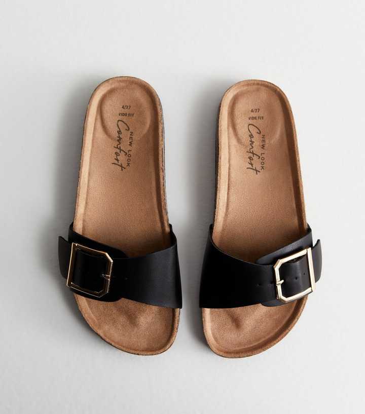 https://media2.newlookassets.com/i/newlook/883570001/womens/footwear/wide-fit-black-leather-look-buckle-sliders.jpg?strip=true&qlt=50&w=720