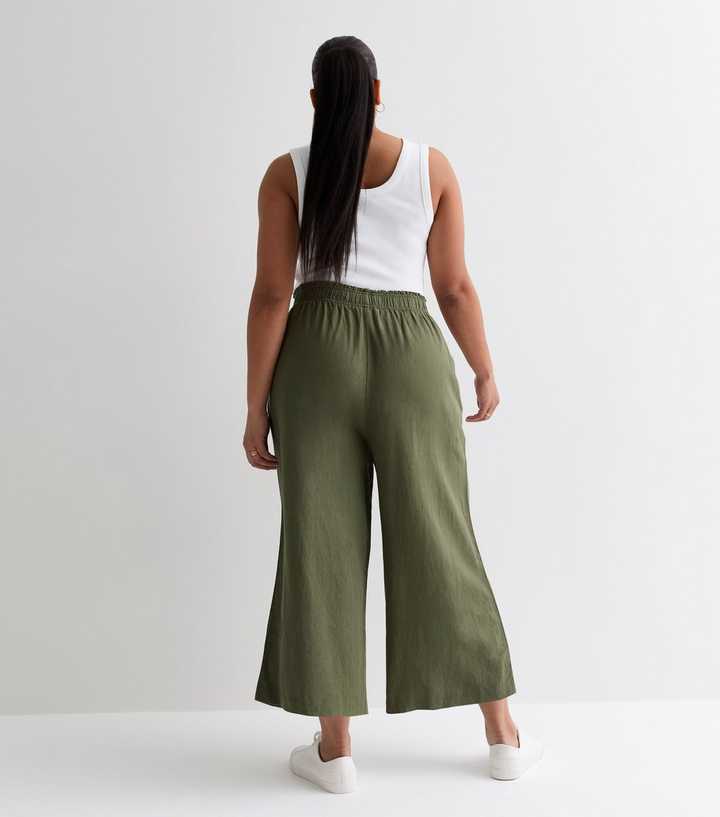 https://media2.newlookassets.com/i/newlook/887247534M3/womens/clothing/trousers/curves-khaki-linen-wide-leg-crop-trousers.jpg?strip=true&qlt=50&w=720