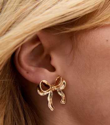 Gold Tone Textured Bow Stud Earrings