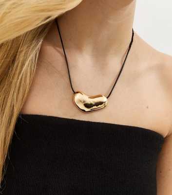Gold Tone Sleek Oval Dome Rope Necklace