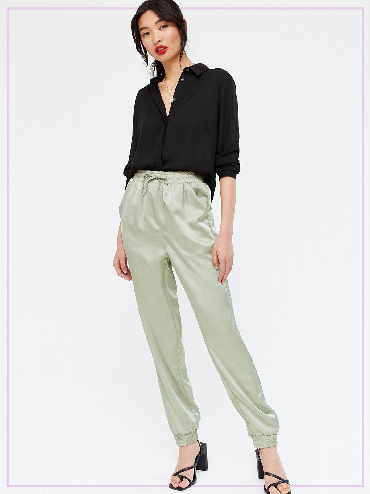 Woman Wearing a Khaki Satin Cuffed Joggers, Black Blouse and Heels