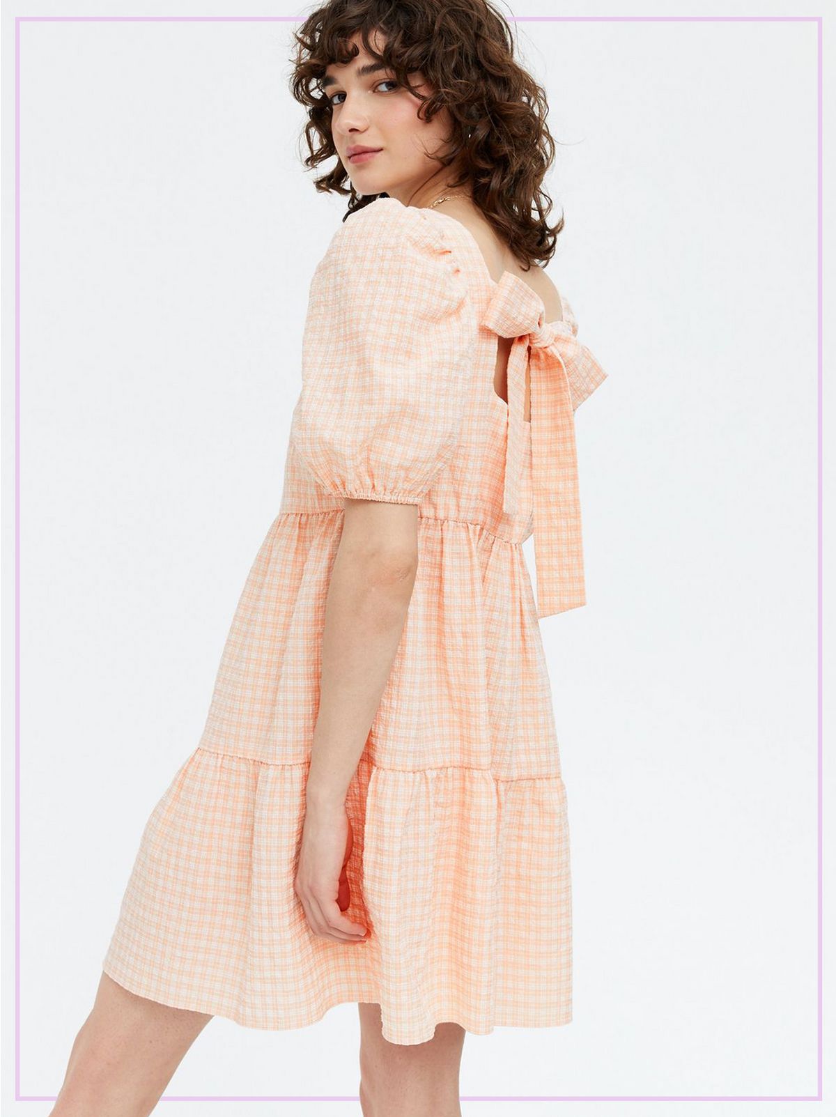 Woman Wearing a Orange Check Tie Back Tiered Smock Mini Dress