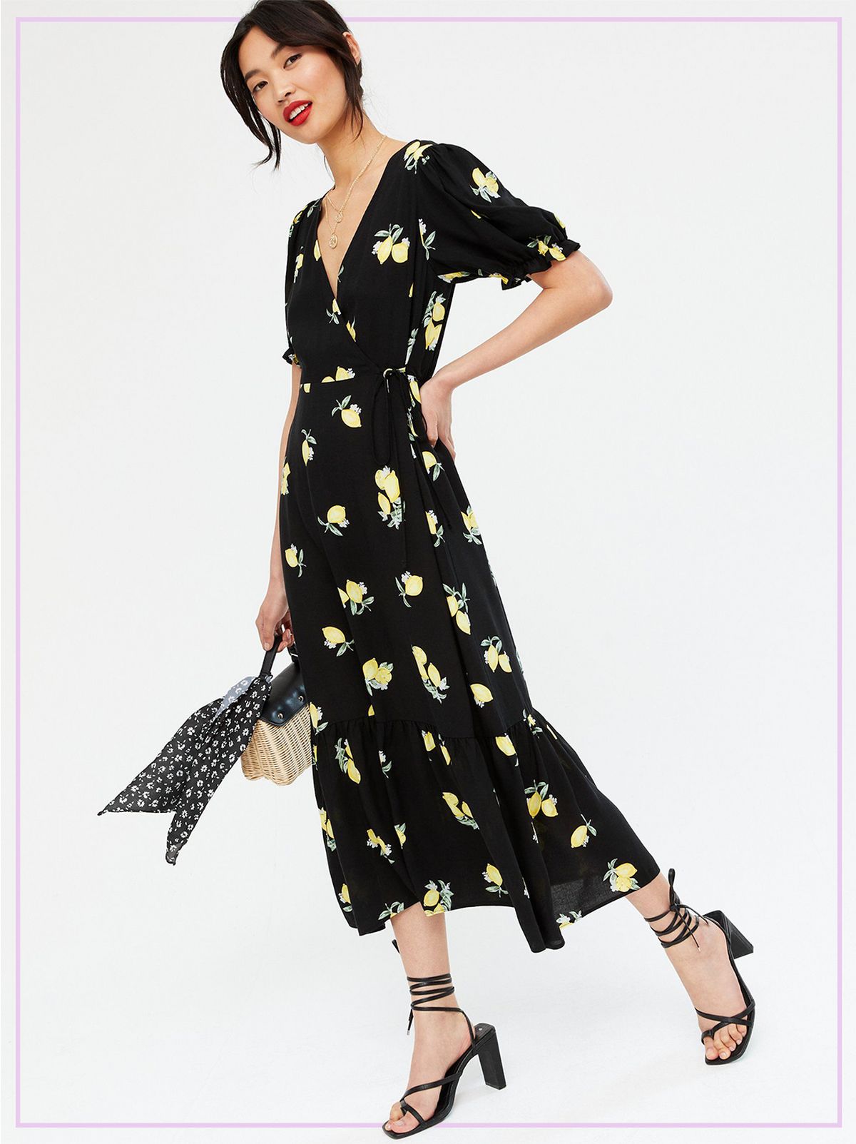 Woman Wearing a Black Lemon Tiered Wrap Midi Dress and Black Strappy Heels