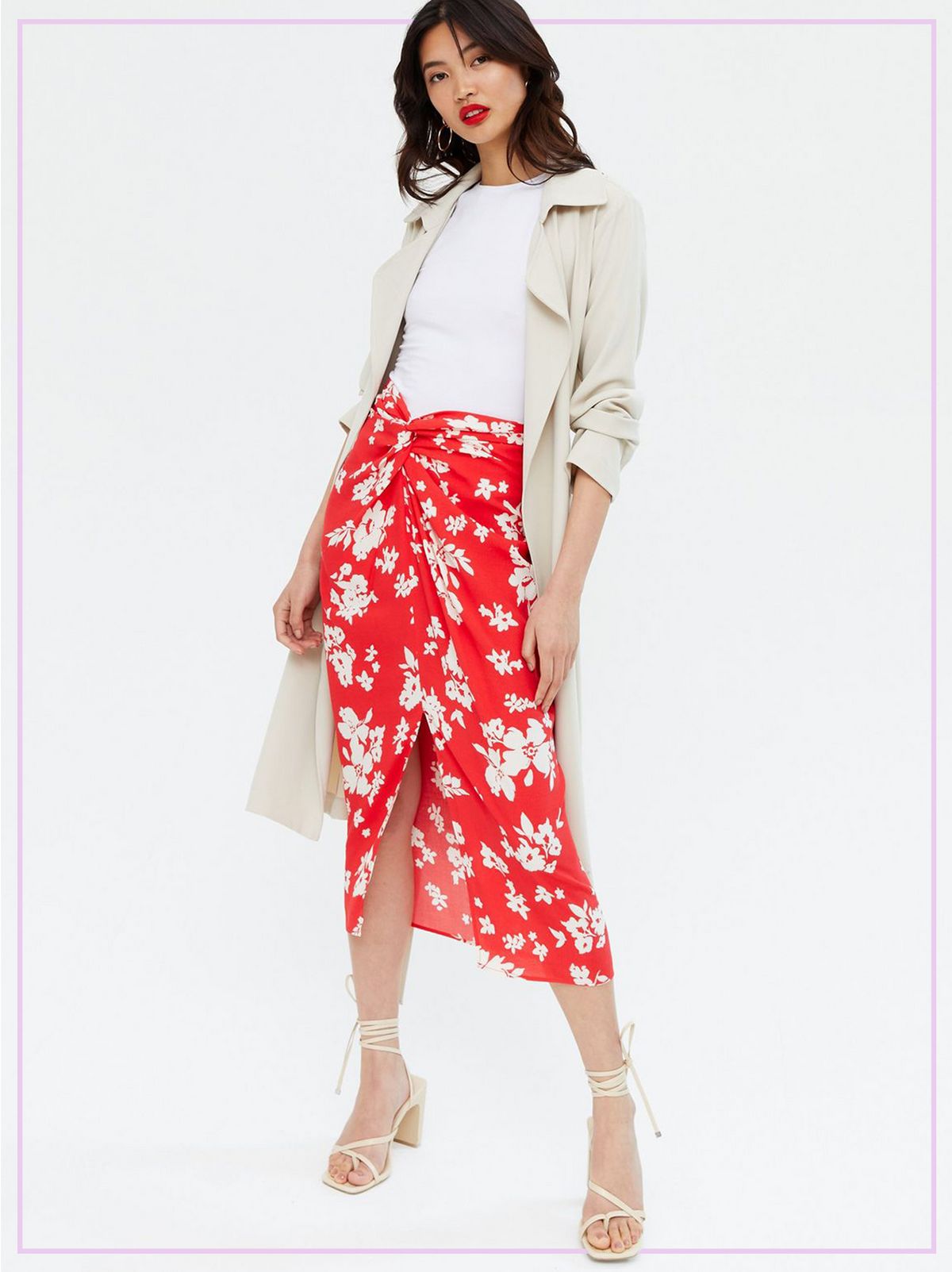 Woman Wearing a Red Floral Knot Front Midi Skirt, White T Shirt, Cream Jacket and Heels