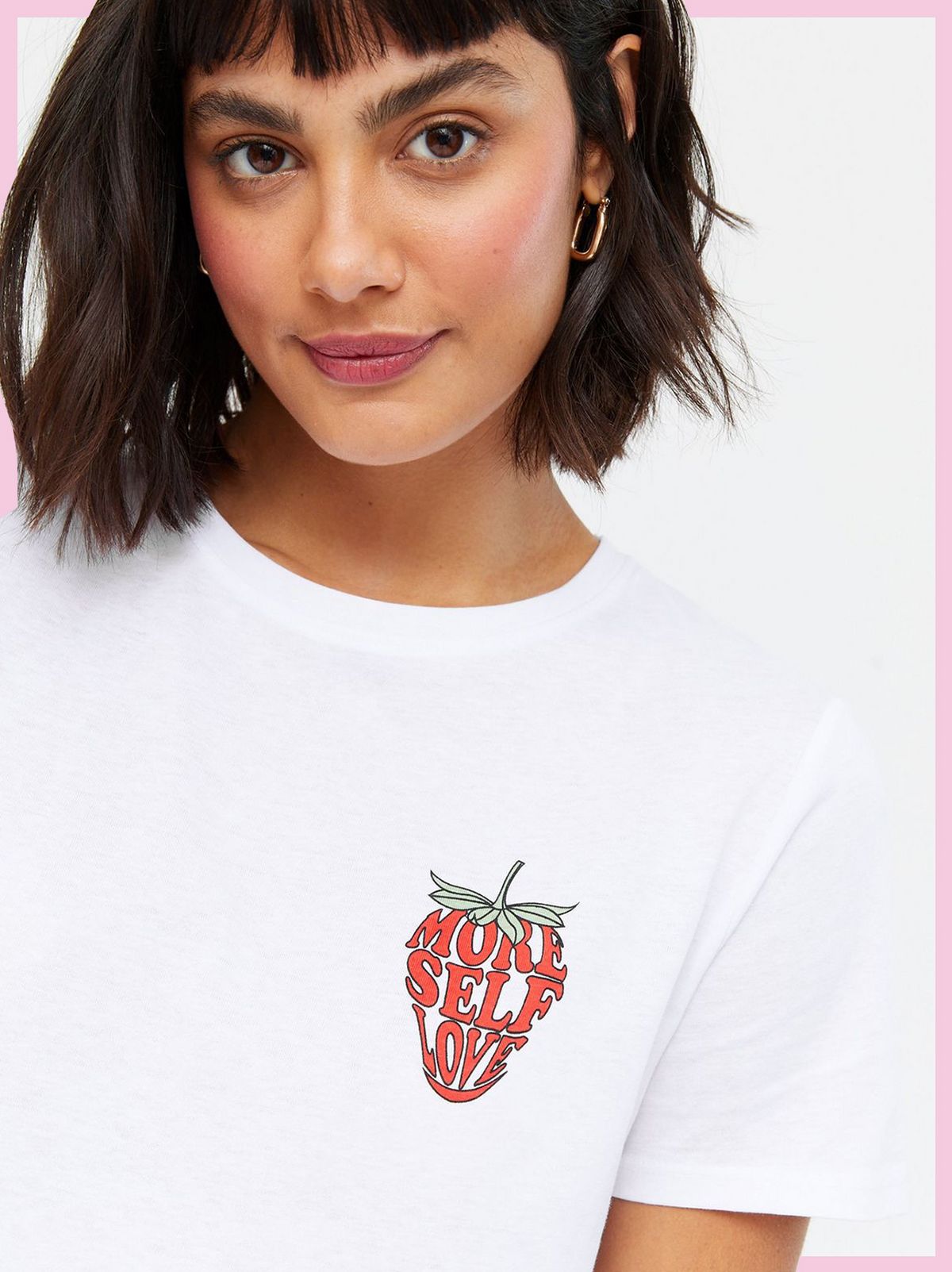 Woman wearing a White More Self Love Strawberry Logo T-Shirt