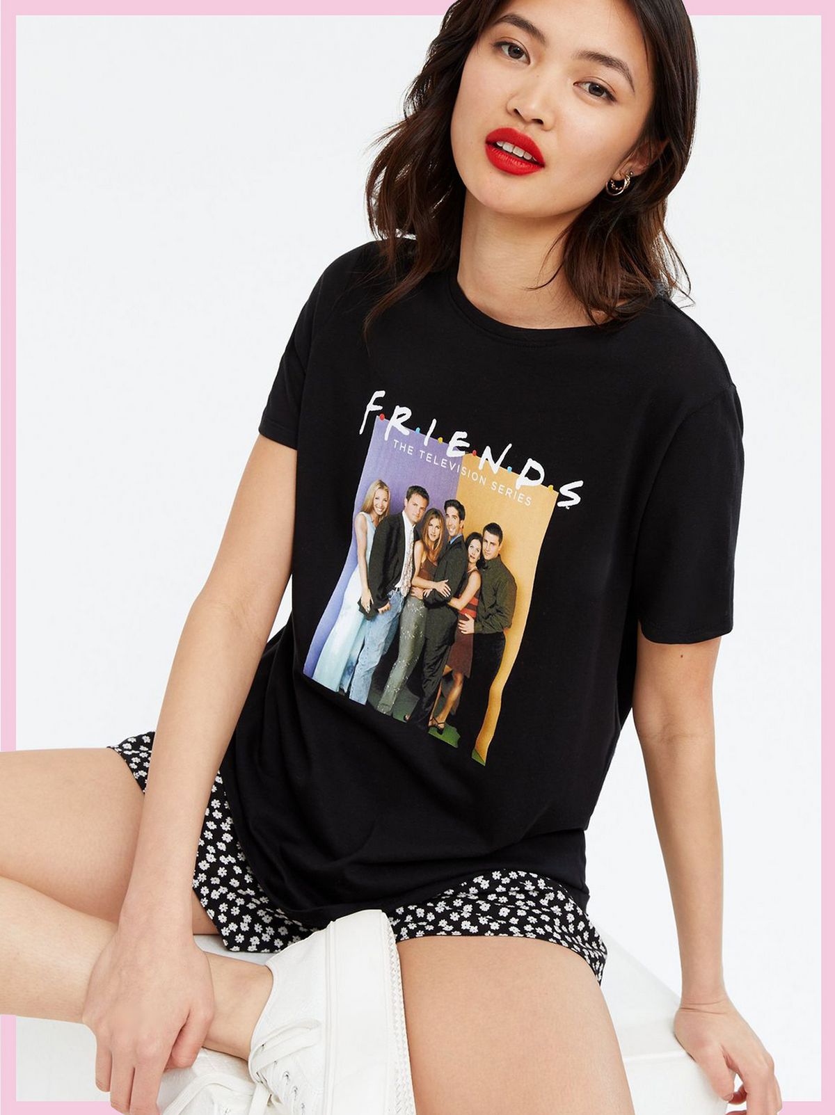 Woman wearing a Black Photo Friends Logo T-Shirt, Spotted shorts and white trainers