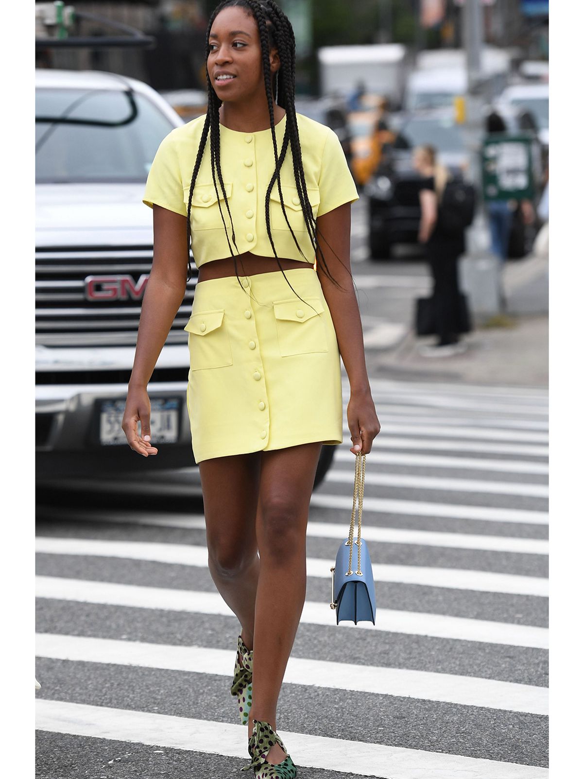Woman wearing a faux croc pencil skirt with a white shirt and stilettos
