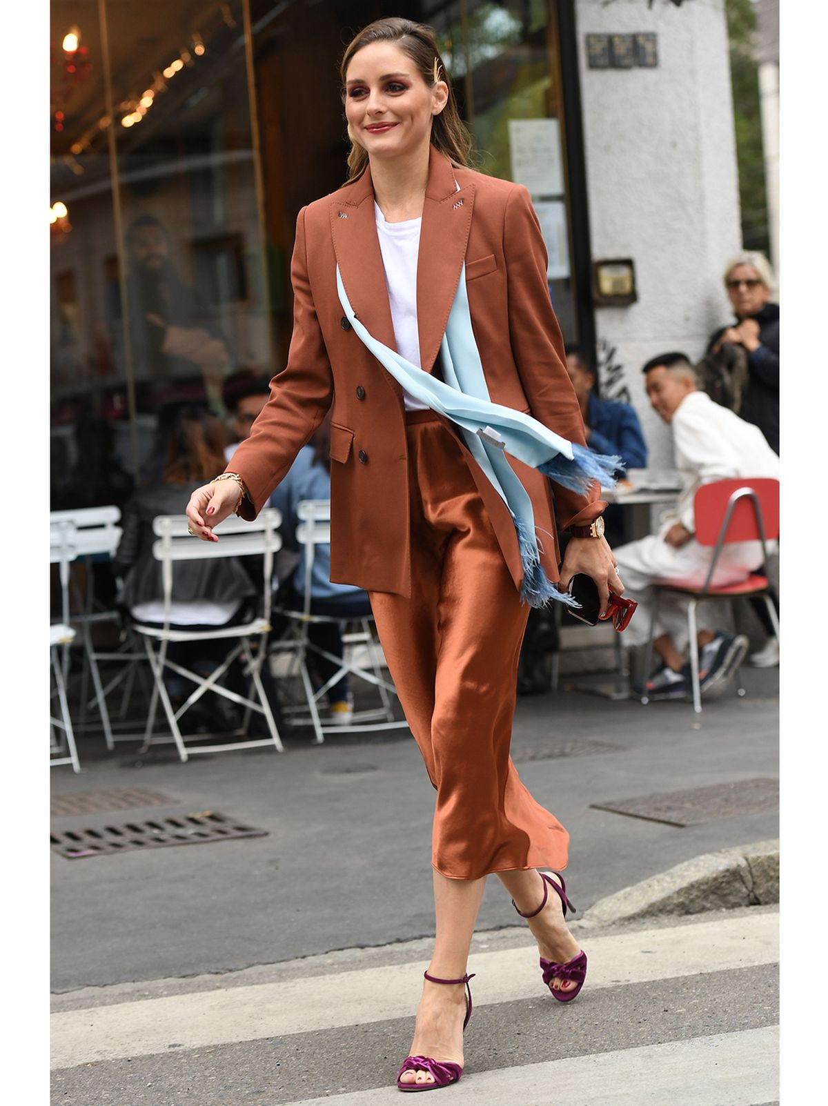 Olivia Palermo crossing the road wearing a midi satin skirt, blazer, scarf and heels