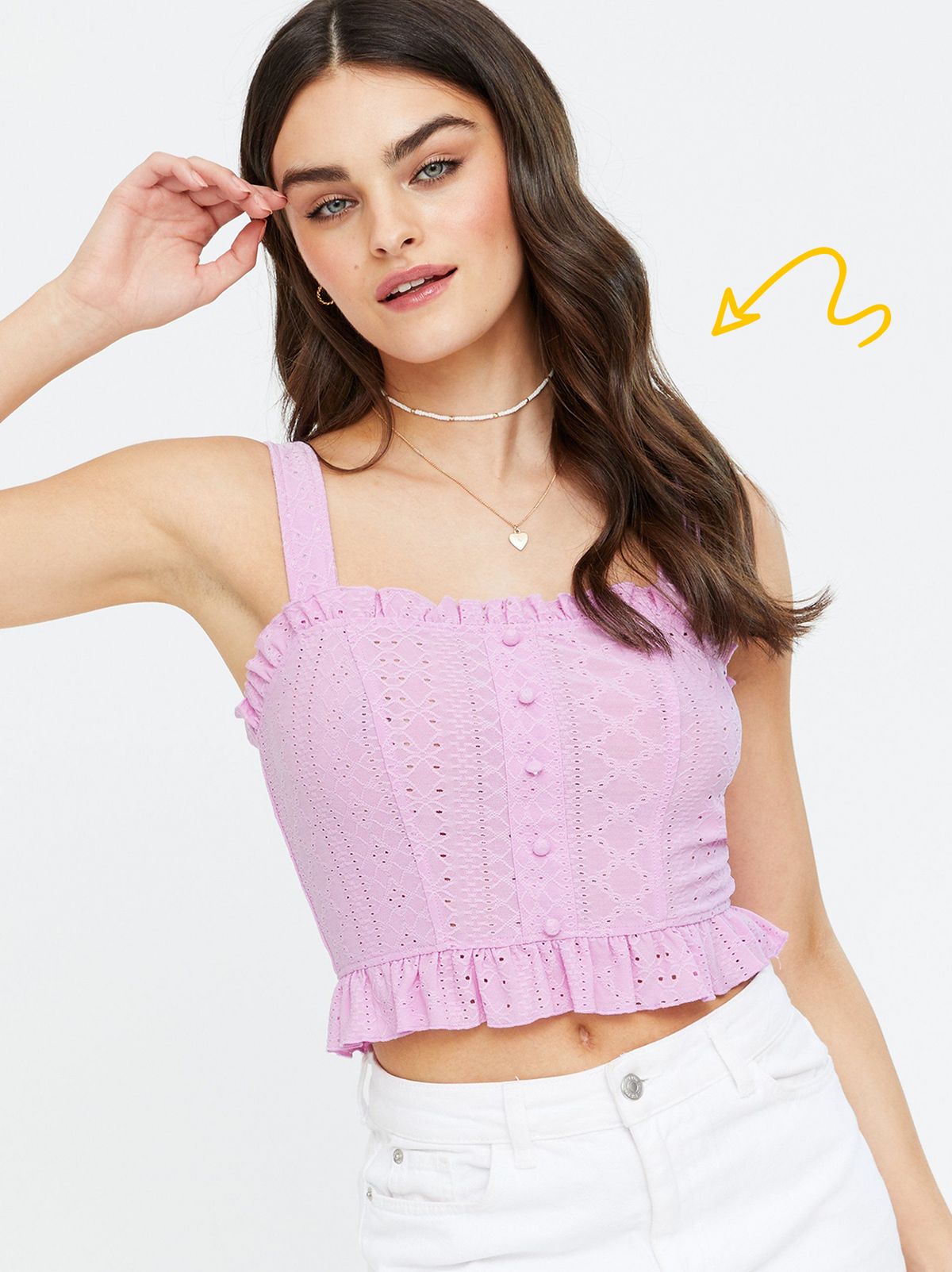 Woman wearing a Lilac Broderie Button Front Frill Crop Cami and white denim shorts