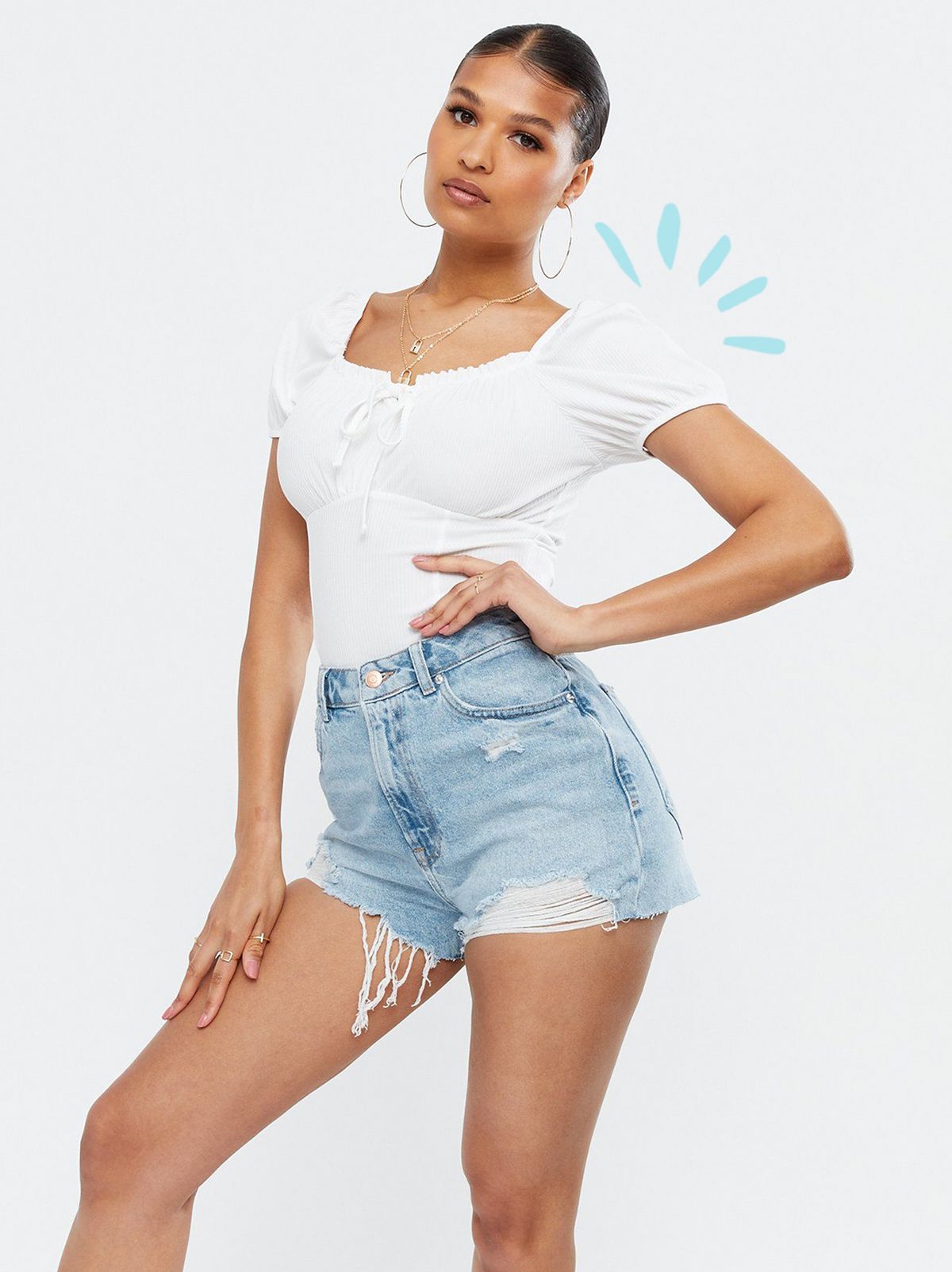 Woman wearing a Bright Blue Ripped Denim High Waist Mom Shorts, white top and white heels