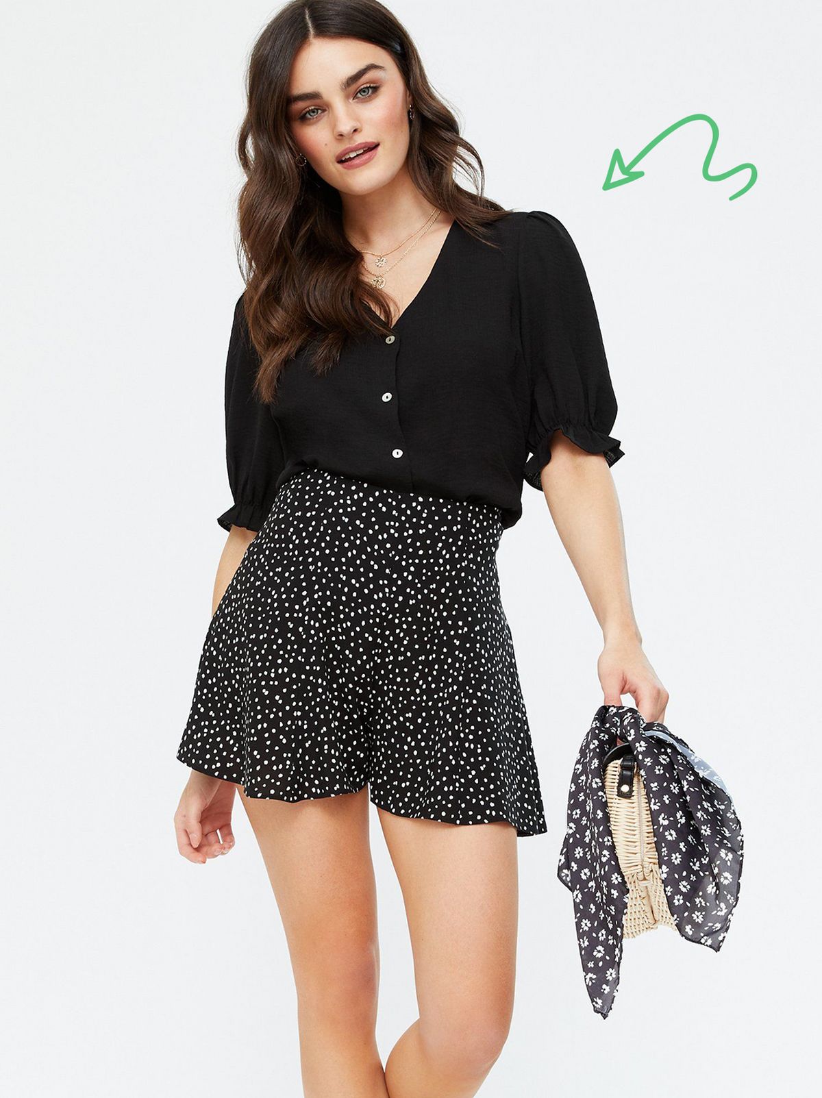 Woman wearing a Black Spot Flippy Shorts, black blouse and strappy sandals