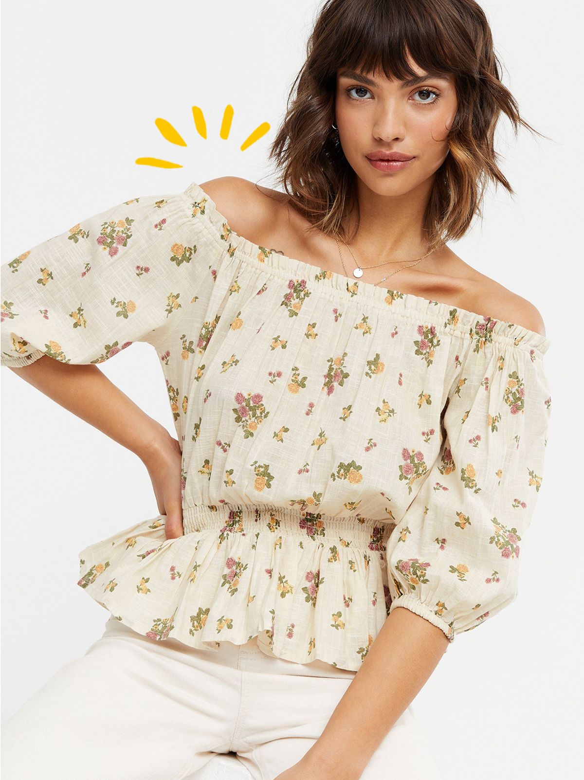 Woman wearing a Off White Floral Sleeve Peplum Bardot Blouse and cream shorts