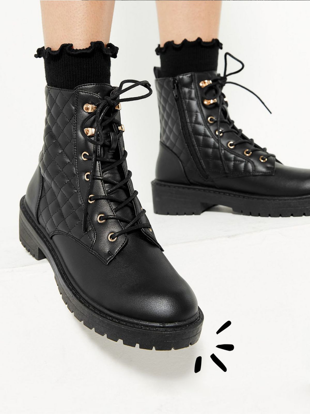 black quilted lace up cleated sole boots