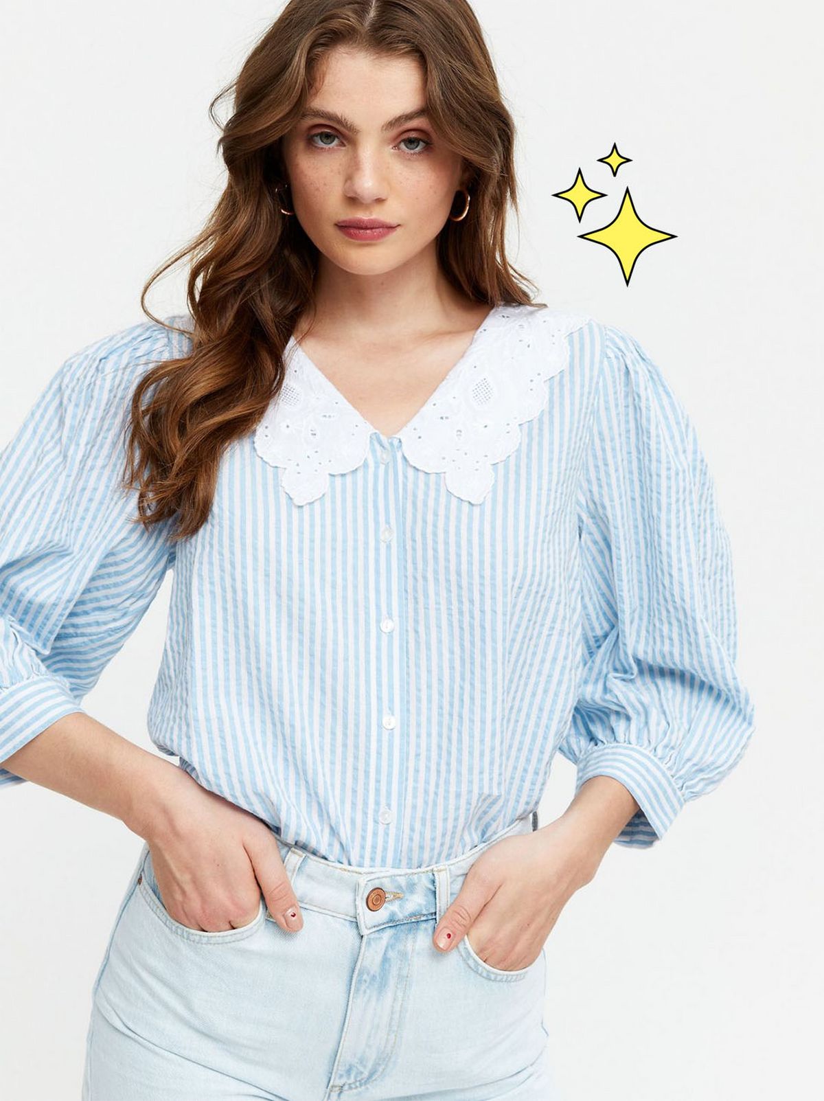 Woman wearing a blue stripe puff sleeve shirt and light blue jeans