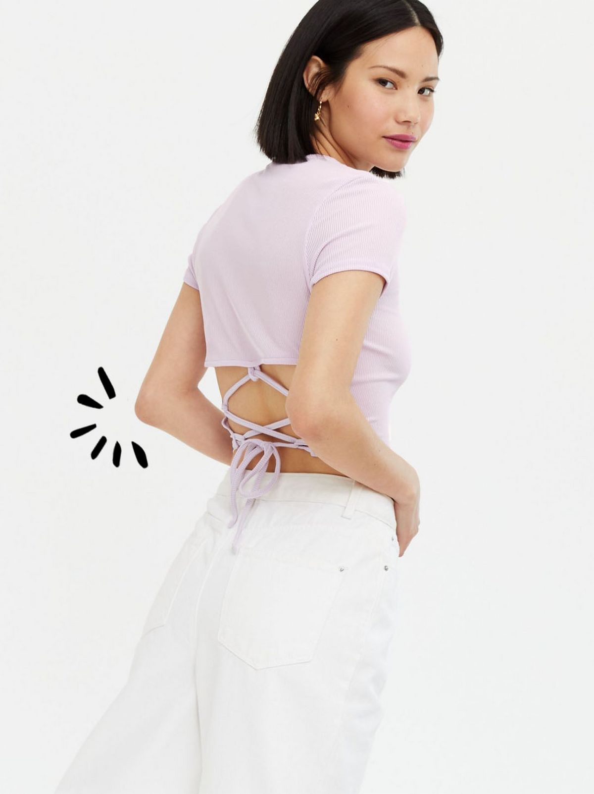 Woman wearing a lilac cop t-shirt and white trousers