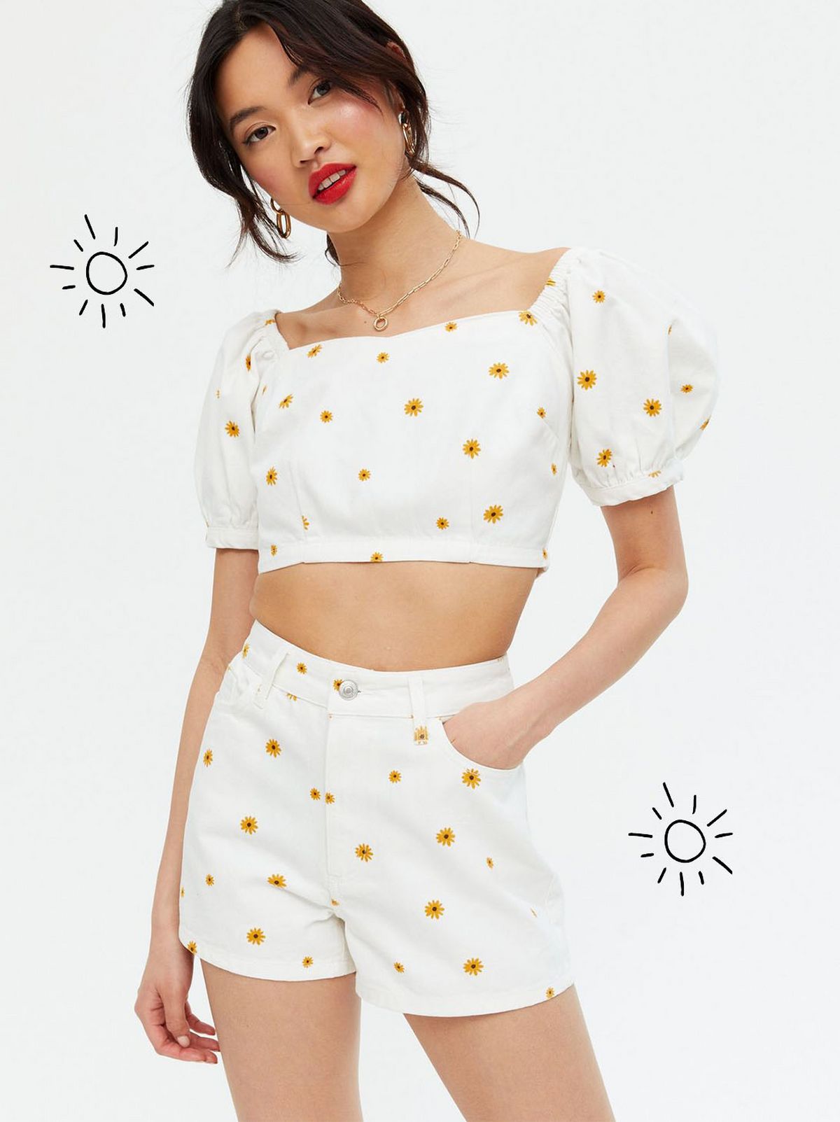 Woman wearing a white sunflower denim crop top and matching shorts